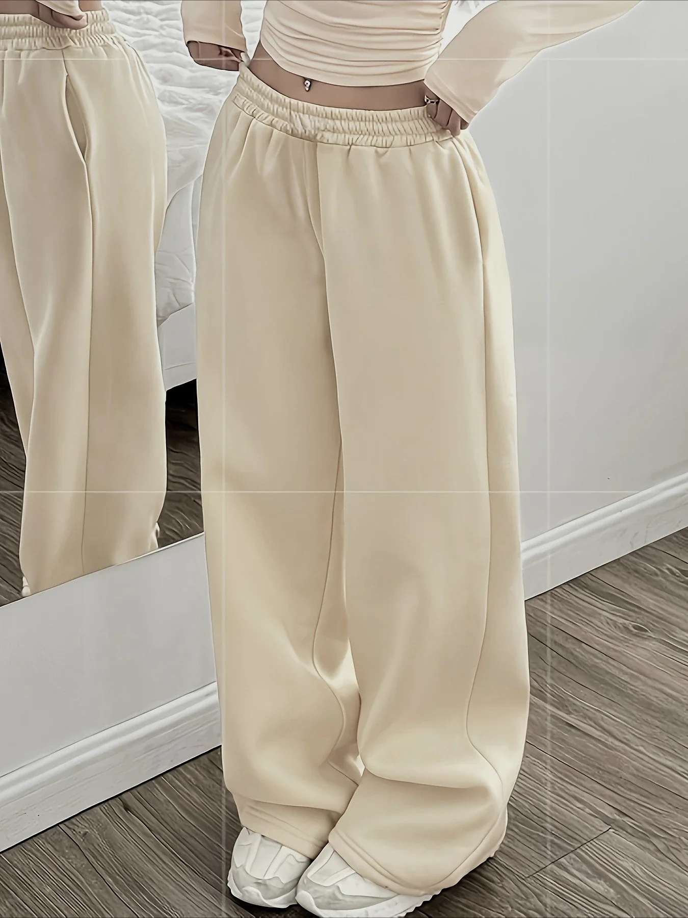 Model wearing the cream ruched crop top and wide-leg set